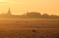 Frosty sunset, fields, sheep, church steeple