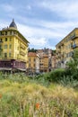 View over grass and plants to historic, colorful buildings in Nice, France. Royalty Free Stock Photo