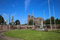 View over green roundabout with towers of two churches St. Walburgiskerk and Eusebiuskerk against blue summer sky