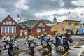 View over group of motorbikes left by motorbike tourists in harbor in Husavik, a northern capital for whale watching safari in