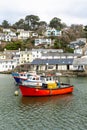 Red Fishing boat moored in the historic and quaint Polperro Harbour in Cornwall, UK Royalty Free Stock Photo