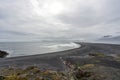 View over Hvalnes beach ,the atlantic ocean and black lava sand with foot prints all over. Royalty Free Stock Photo