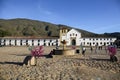 View over the impressive Plaza Mayor to the Church of our Lady of the Rosary, blue sky and mountains in the back, Villa de Leyva,