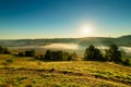 A view over the Jeker valley covered in mist in the rolling hill landscape of south Limburg Royalty Free Stock Photo