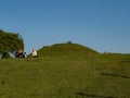 View over Krakus mound with people standing on the top and relaxing on the grassland. Coronavirus time.