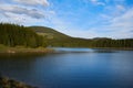 A view over the Lake Oasa in Mountains Sureanu with sky with clouds and forest Royalty Free Stock Photo