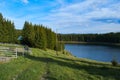 A view over the Lake Oasa in Mountains Sureanu with sky with clouds and forest Royalty Free Stock Photo