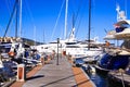 View over landing stage of mediterranean Harbour on luxury yachts and sail ships against blue sky Royalty Free Stock Photo