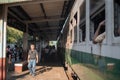 View over local burmese people at a platform stop with the traditional circle train