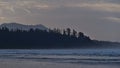 View over Long Beach in Pacific Rim National Park Reserve, Canada in the morning with rough sea and the silhouette of rainforest. Royalty Free Stock Photo