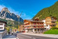 View over magical Dolomite peaks, forests and hotels at sunny day and blue sky, Colfosco, Corvara, at Puez-Geisler, Puez-Odle