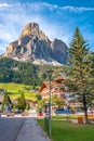 View over magical Dolomite peaks, forests and hotels at sunny day and blue sky, Colfosco, Corvara, at Puez-Geisler, Puez-Odle