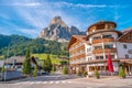 View over magical Dolomite peaks, forests and hotels at sunny day and blue sky, Colfosco, Corvara, at Puez-Geisler, Puez-Odle