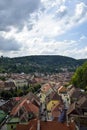 View over medieval fortress Sighisoara city, Transylvania. Ancient city from observation tower against background of mountains Royalty Free Stock Photo