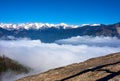 View over the mountain landscape and over the clouds with rocks in the foreground