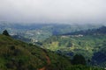 A view over mountain vilage in Costa Rica from elevated viewpoint with low hanging cloud and lush vegetation