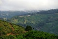 A view over mountain vilage in Costa Rica from elevated viewpoint with low hanging cloud and a rural unimproved road Royalty Free Stock Photo