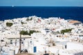 View over Mykonos town at noon with traditional sailing boat