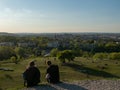 View over old town of Cracow from Krakus mound. In the front people relaxing on the grassland. Wide shot