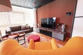 View over orange retro armchair with view into modern living room Royalty Free Stock Photo