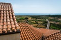 View over orange tiled roofs towards fields and Posada beach, Sardinia Royalty Free Stock Photo