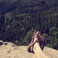 View over own legs to the word. Sandstone rock above valley