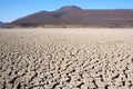 View over parched and empty dam, with cracked mud Royalty Free Stock Photo