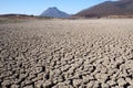 View over parched and empty dam, with cracked mud Royalty Free Stock Photo