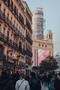 View over people of Edificio Capitol on Gran Via, Madrid, Spain, shallow focus