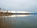 Greifensee, Switzerland - April 7th 2023: Plain water surface of lake Greifensee with the Alps Royalty Free Stock Photo