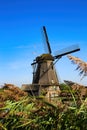 View over reed grass on one old dutch windmill against blue summer sky - Kinderdijk, Netherlands Royalty Free Stock Photo