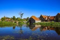 View over reflecting river pond on old water mill restaurant against deep blue cloudless summer sky - Neer Limburg, Netherlands Royalty Free Stock Photo