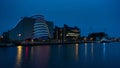 Modern Convention Centre in Dublin, Ireland at night with reflections in river