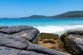 View over rocks at Pebbly Beach, a popular camping area with great surfing beach and bush walks within Murramarang National Park, Royalty Free Stock Photo