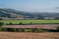 View over rolling english countryside at sunset in summer under blue sky Royalty Free Stock Photo