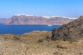 A view over the rugged landscape on the volcanic island of Nea Kameni, Santorini with Thira and the caldera in the background Royalty Free Stock Photo