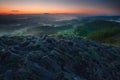 View over sharp peak of basalt formation into misty valley Royalty Free Stock Photo