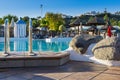 at the pool edge at resort hotel with ladder into the water besides some rocks Royalty Free Stock Photo