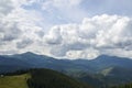 View over spruce forest, green meadow and Chornohora ridge with mount Hoverla and Petros Carpathians, Ukraine