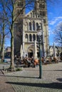 View over square with exterior cafe, old medieval church on sunny winter day Royalty Free Stock Photo