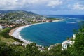 A view over St. Kitts Island with residential area and beaces on the foreground and lush green hills on the background