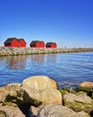 View over the stone groyne to the fishermen's houses at the harbor Weisse Wiek in Boltenhagen at the Baltic Sea. Germany