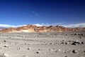 View over stony barren wasteland on colorful red hills contrasting with deep blue sky in the nowhere of Atacama desert, Chile