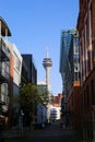 View over street in office district on television tower on sunny day Focus on tower