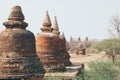 View over stupas and pagodas of ancient Bagan temple complex during sunrise golden hour in Myanmar Royalty Free Stock Photo