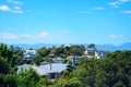 View over suburbian area of Wellington with mountains in the distance on a bright sunny day.