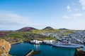 View over town of Heimaey and volcano Helgafell and Eldfell in Iceland