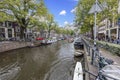 View over a typical canal in the Dutch metropolis Amsterdam in summer 2023