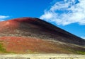 View over valley on isolated surreal ridge of barren colorful dry red, black and green
