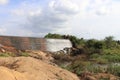 View of a Overflowing dam made from natural building materials like bricks surrounded by greeneries and rocks Royalty Free Stock Photo